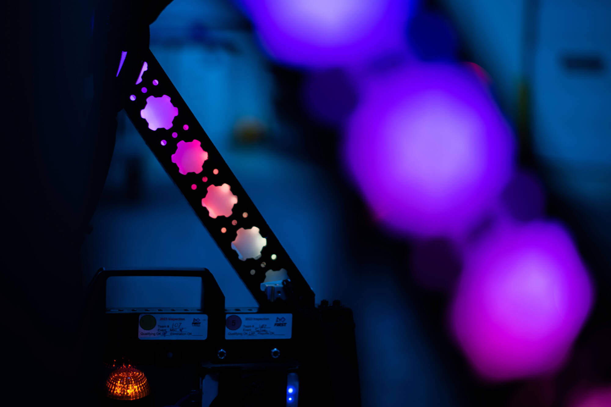 Colorful light panel with pink and purple flights. Power button and indicator lights are visible.